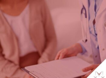 #pratodosverem: artigo: O CID do fingimento de doença pelo trabalhador. Na foto uma médica está conversando com uma paciente. Cores na imagem: vermelho, branco, azul, marrom e bege.